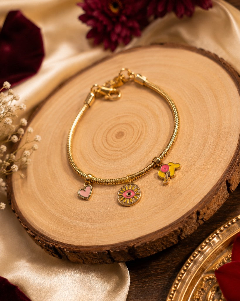 Anti-Tarnish Gold Charm Bracelet on wood slice